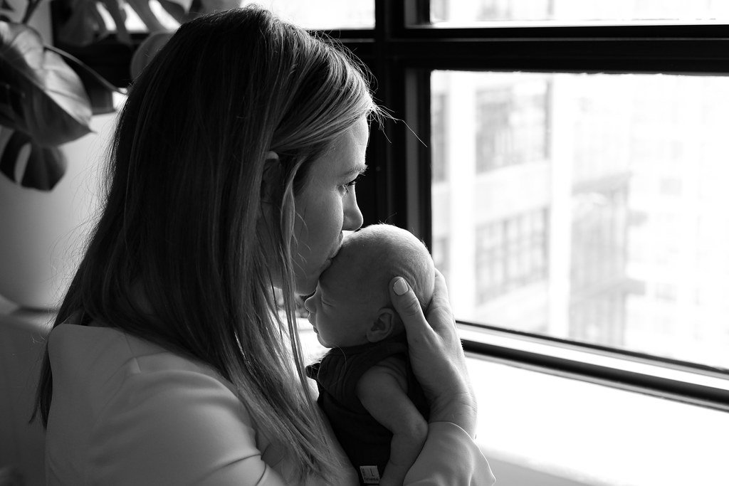 Artful photography of family embrace and newborn connection
